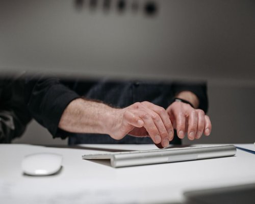 Close up of good posture and ergonomic hands position at a modern standing desk